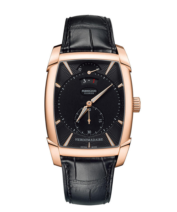 <b>PARMIGIANI FLEURIER</b></br>パルミジャーニ・フルリエ</br></br><b>カルパ エブドマデール</b><hr><b>典雅なトノーに潜むロングパワーリザーブ</b></br>クラシカルなトノーに力強い印象を与える大型ラグの形状は、黄金比に基づく。ダイヤルでは、複雑なトレス模様のギョーシェが華やぐ。入念に作り込まれた外観に、トノー専用の８日巻き自社製ムーブメントを潜めた。その機械も完璧に手仕上げされ、機械式時計としての真の価値を宿す。手巻き。ケース42.3 × 32.1mm。18KRGケース。アリゲーターストラップ。340万円（パルミジャーニ・フルリエ）