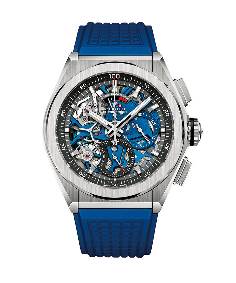 <b>ZENITH</b></br>ゼニス</br></br><b>デファイ エル・プリメロ21</b><hr><b>革新的1/100秒クロノグラフが爽やかに装う</b></br>1/100 秒単位で正確に計測できる革新的クロノグラフ・ムーブメントをチタンケースに搭載。大胆なフルオープンのダイヤルに見せるムーブメントのパーツの一部を、鮮やかなブルーに染め上げた新色である。斬新な機構と外観が、爽やかな印象をまとう。12時位置には、クロノグラフ用の50分パワーリザーブ計を装備。自動巻き。径44mm。チタンケース。ラバーストラップ。128万円（LVMH ウォッチ・ジュエリー ジャパン ゼニス）